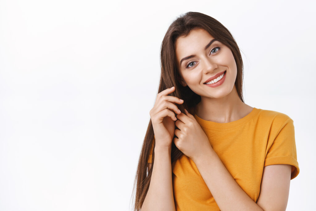 close up tender feminine alluring girlfriend taking care her hair touching strands tilt head smiling satisfied with good haircare product she applied make hairstyle white background &raquo; % Hair Care